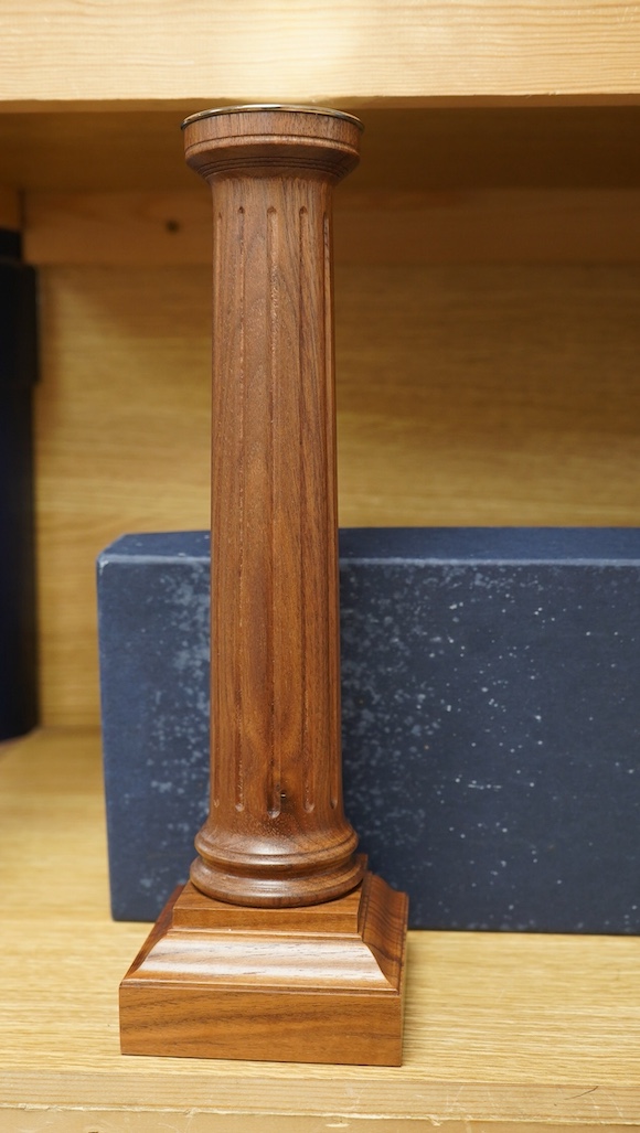 A pair of David Linley walnut candlesticks in the form of fluted columns, 30cm high, with the original card box. Condition - some notable water damage to the box, otherwise good.